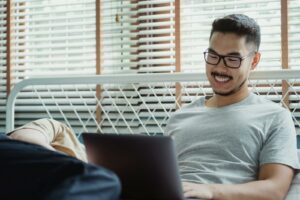 Portrait of Happy Man Using Laptop