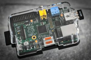 Detailed image of a Raspberry Pi microcomputer circuit board in a clear case.